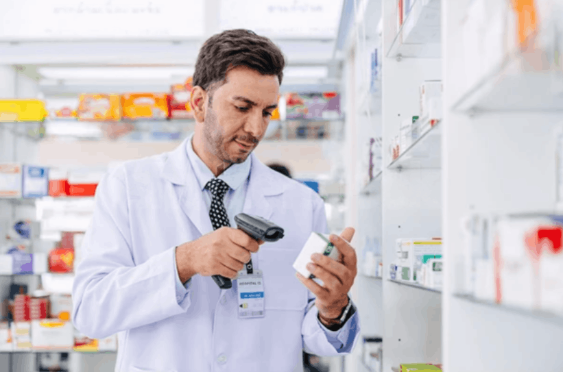 Pharmacist reviewing prescription on laptop for personalized treatments